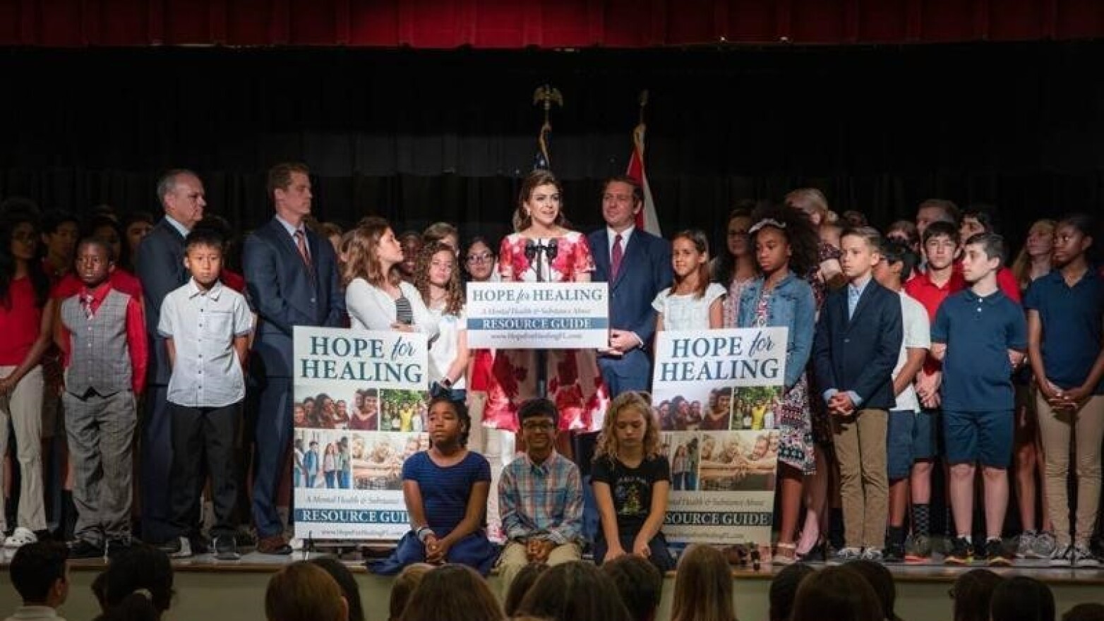 Florida First Lady Casey DeSantis (at podium) announces her Hope for Healing campaign.